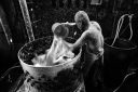 Duck man de-feathering his ducks